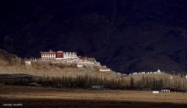 Phyang Monastery on its hilltop above Phyang village, west of Leh, with the blue mountain rising behind it